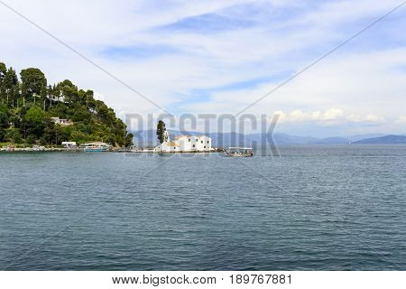 KANONI, GREECE - MAY 15: Tourists visit the old Greek Christian Orthodox church Vlacherna Monastery on May 15, 2017 in Kanoni, Corfu island in Greece.