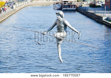 BYDGOSZCZ, POLAND. 8th APRIL 2017. The tightrope-walker sculpture over the River Brda is one of the many cultural attractions that are pulling tourists into the cit of Bydgoszcz in ever greater numbers.
