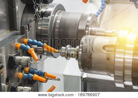 The CNC lathe machine or Turning machine drilling the metal rod with the drill tool and center drill tool .The hi-technology machining concept.