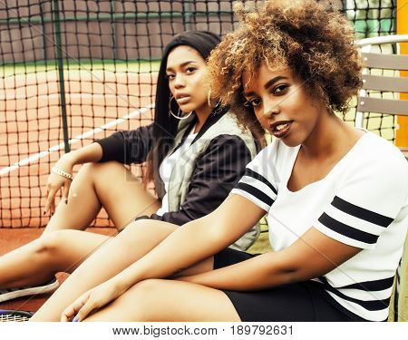 young pretty girlfriends hanging on tennis court, fashion stylish dressed swag, best friends happy smiling together lifestyle, people sport concept close up