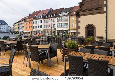 SCHWEINFURT GERMANY - APRIL 21 2017: Restaurant's tables on the market square in the historic part of the city. Schweinfurt - a medieval city founded in 761 year.