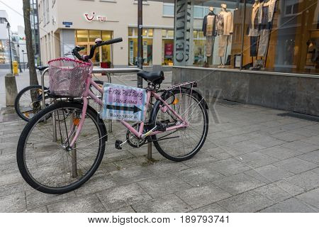 SCHWEINFURT GERMANY - APRIL 21 2017: Pointer to a second-hand shop on an old bicycle in the historic part of the city. Schweinfurt - a medieval city founded in 761 year.
