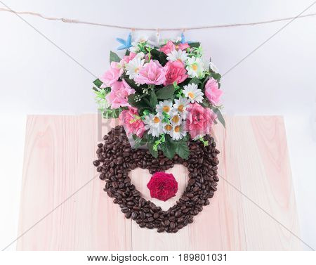 Heart of coffee beans with flowers starfish and white background.
