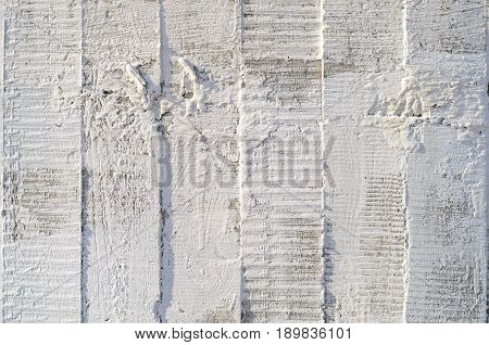 Texture of wooden formwork stamped on a raw concrete wall as background. Vertical strips from formwork