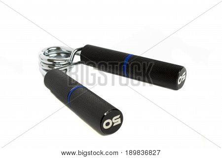 Manual spring loaded carpal expander with metal handles isolated on white background