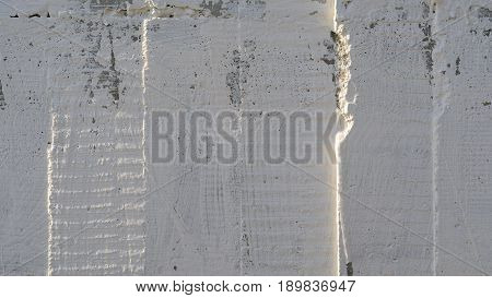 Texture of wooden formwork stamped on a raw concrete wall as background. Vertical strips from formwork