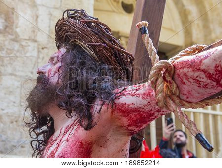 JERUSALEM - APRIL 14 : Christian pilgrim re-enact the crucifixtion of Jesus along the Via Dolorosa in Jerusalem during Good friday on April 14 2017