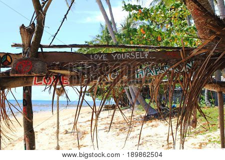 Travel To Island Koh Lanta, Thailand. Inscriptions “love Yourself”, “love Peace Harmony” On The Wood