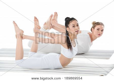 Multiethnic Girls Doing Frog Pose (bhekasana) Isolated On White