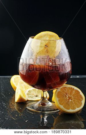 Softdrink With Ice Cubes, Lemon And Straw In Glass
