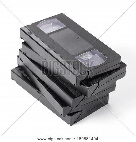 Pile of vintage VHS videotapes on a white background.