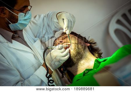 Man at the dentist clinic fixing his teeth