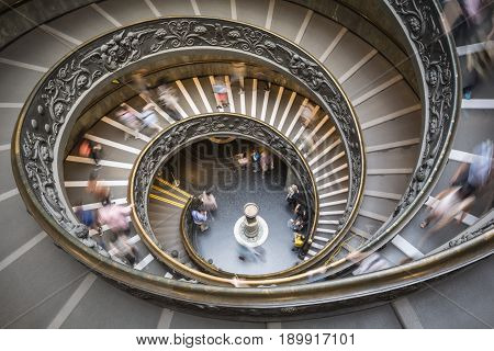 Blurred motion of tourists descending the Bramante staircase inside the Vatican museum