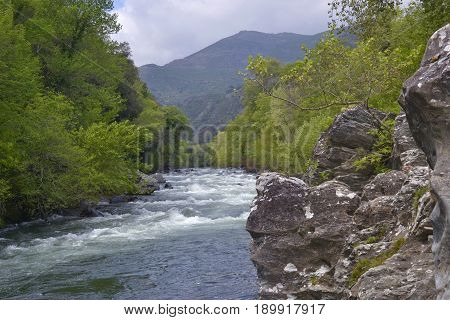 Mountain landscape. River, distant mountains and rocks