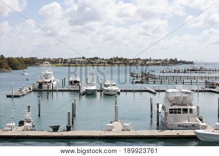 Jupiter FL USA - March 30 2017: Loxahatchee River boats docked in a marina on a mostly sunny day. Many boats parked in docks on the Loxahatchee River.