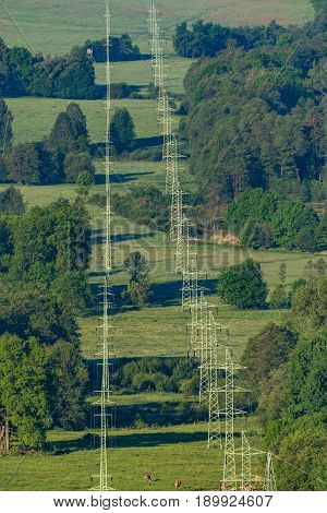 High-voltage power lines in a green landscape
