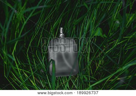 male bottle of perfume over green background