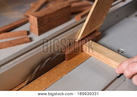 Circular saw sawing merbau wood brick closeup
