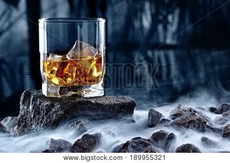 Glass Of Whiskey And Ice.creative Photo Glass Of Whiskey On Stone With Fog And Cold Background.copy