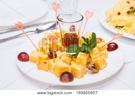 Cubes of yellow cheese on the plate