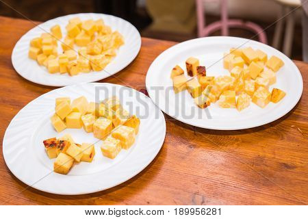 Cubes of yellow cheese on the plate