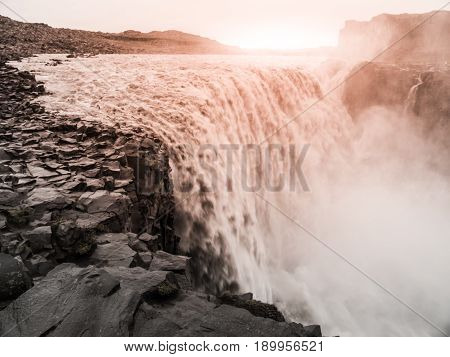 Detifoss waterfall illuminated by sunset, northern Iceland.