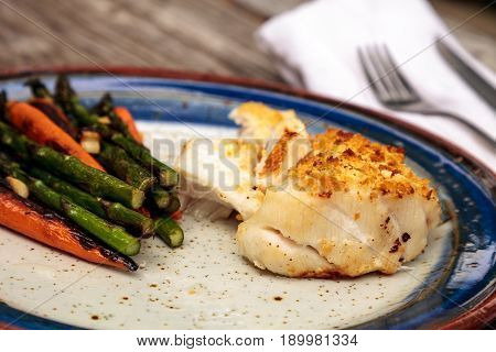 White Flakey Sea Bass With Breadcrumbs And Roasted Asparagus And Carrots