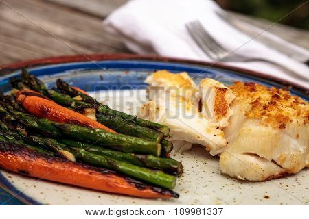 White Flakey Sea Bass With Breadcrumbs And Roasted Asparagus And Carrots