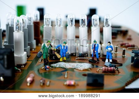 Miniature cleaner peoples are cleaning on circuit board