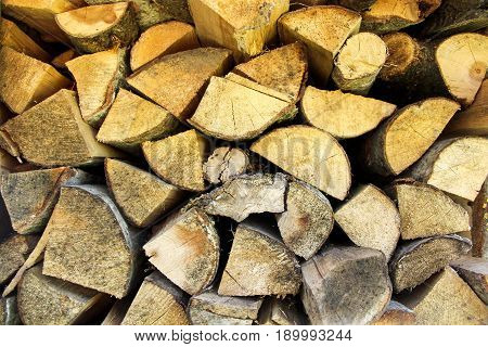 wooden firewood stacked texture bacground close up
