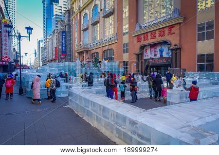 Harbin, China - February 9, 2017: Unknown tourists visiting the ice sculptures in Zhongyang pedestrian street, central street is a commercial long corridor of European architectural art