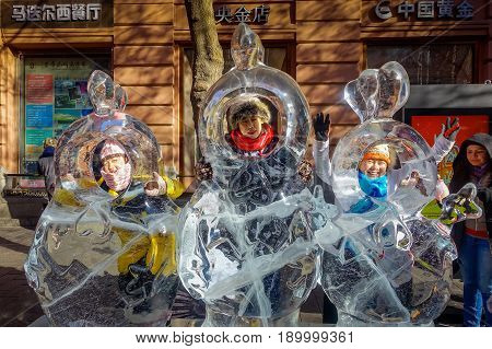 Harbin, China - February 9, 2017: Unknown tourists visiting the ice sculptures in Zhongyang pedestrian street, central street is a commercial long corridor of European architectural art