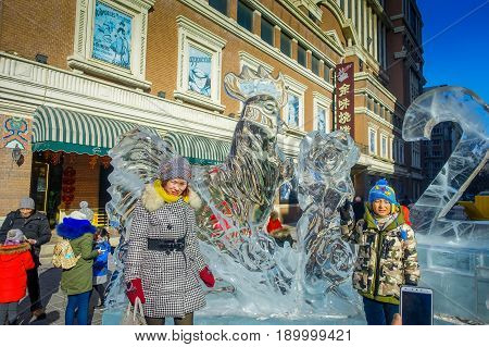 Harbin, China - February 9, 2017: Unknown tourists visiting the ice sculptures in Zhongyang pedestrian street, central street is a commercial long corridor of European architectural art