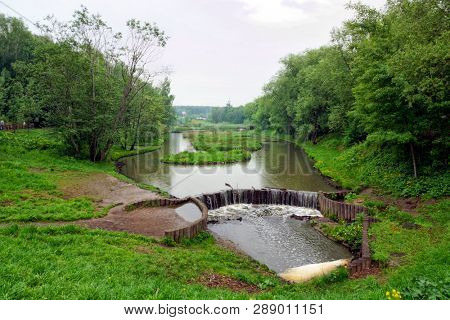 Chermyanka river in a park in Moscow, cloudy weather.