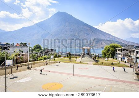 Santiago Atitlan, Lake Atitlan, Guatemala - March 8, 2019: Kids Play In Lakeside Basketball Court Wi