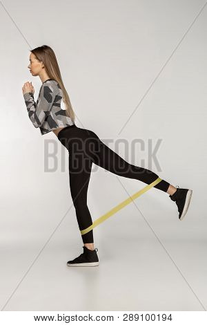 Attractive Sportswoman Performs Exercises With Resistance Band