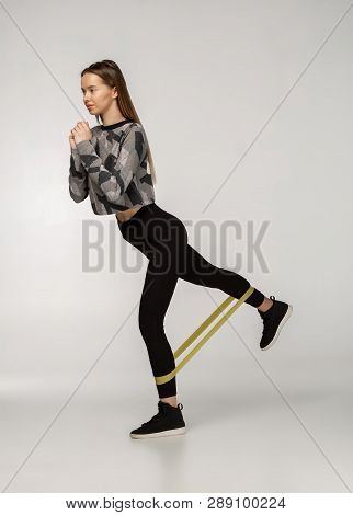 Attractive Sportswoman Performs Exercises With Resistance Band