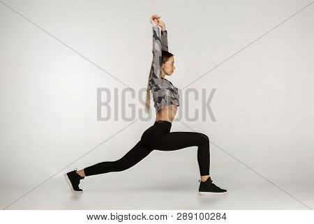 Young Sporty Attractive Woman Practicing Yoga Doing Reverse Warrior Exercise