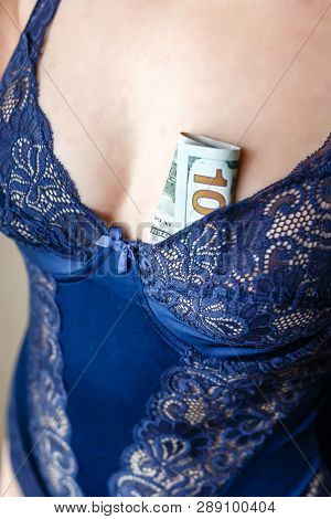 Young Woman Dressed In Blue Lingerie Hold A Money, New One Handred Dollars Banknotes.