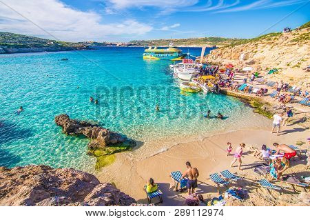 Comino, Malta - November, 2018: Tourists Crowd At Blue Lagoon To Enjoy The Clear Turquoise Water On