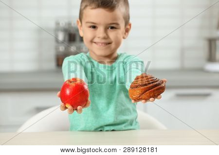 Little Boy With Pastry And Apple At Home. Diabetes Diet