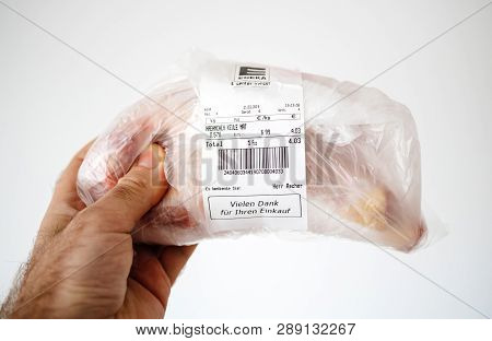 Karlsruhe, Germany - Mar 12, 2019: Male Hand Holding Plastic Package With Edeka Supermarket Logotype