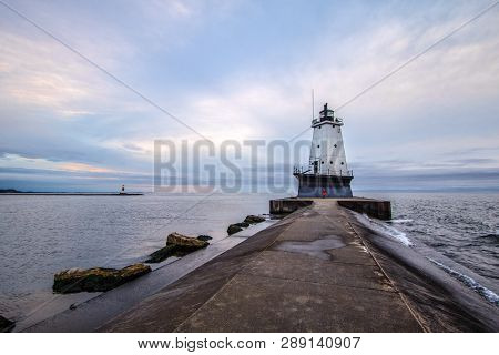 Ludington Lighthouse. Lighthouse On The Coast Of Lake Michigan Under An Overcast Grey Sky.