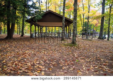 Autumn At Michigan State Parks. Picnic Shelter Surrounded By Vibrant Fall Foliage On A Warm Autumn D
