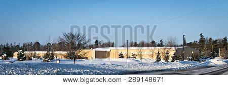 Bemidji, Mn - 12 Mar 2019: Metal Industrial Buildings Housing A Curling Club Near A Road In Winter W