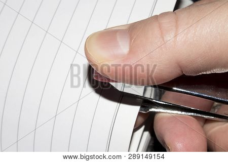 Stapling Paper With Staples.stapler In The Hand Of Man.