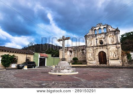 Church Fassade Ruin Of Ermita De Santa Isabel And Cross On Plazawith Dramatic Blue Cloudscape, Antig