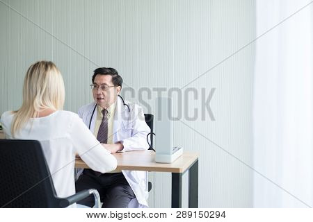 Man Doctor Examining To Woman Patient,infertility Counseling And Suggestion At Hospital