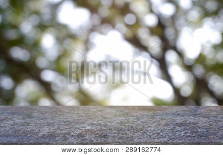 Empty Marblestone Table In Front Of Abstract Blurred Green Of Garden And Nature Light Background. Fo