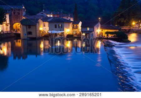 Panoramic night view of Borghetto (Valeggio sul Mincio, Verona) from the bridge on the river Mincio